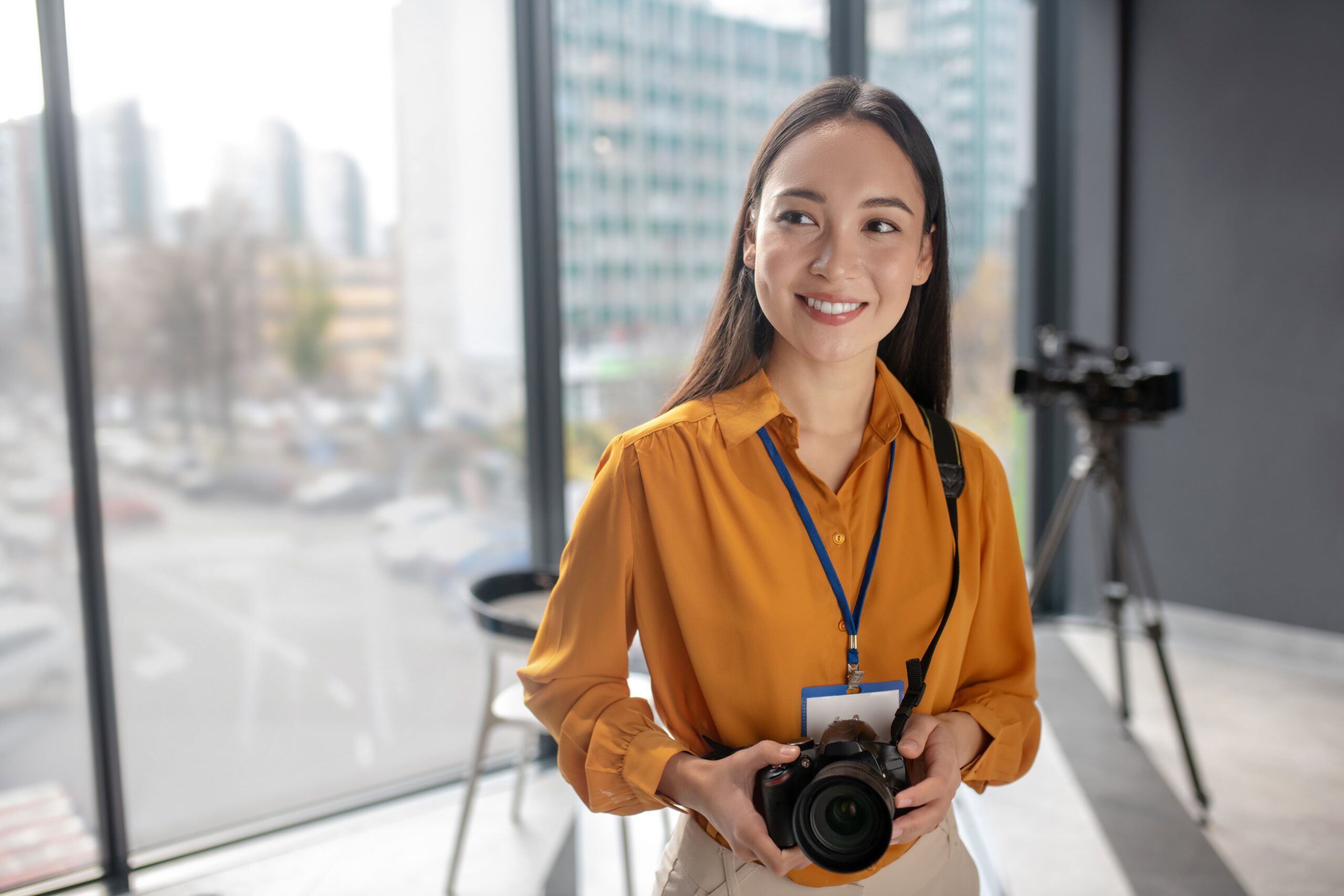 dark-haired-young-cute-reporter-holding-a-camera-2023-11-27-04-50-21-utc-min
